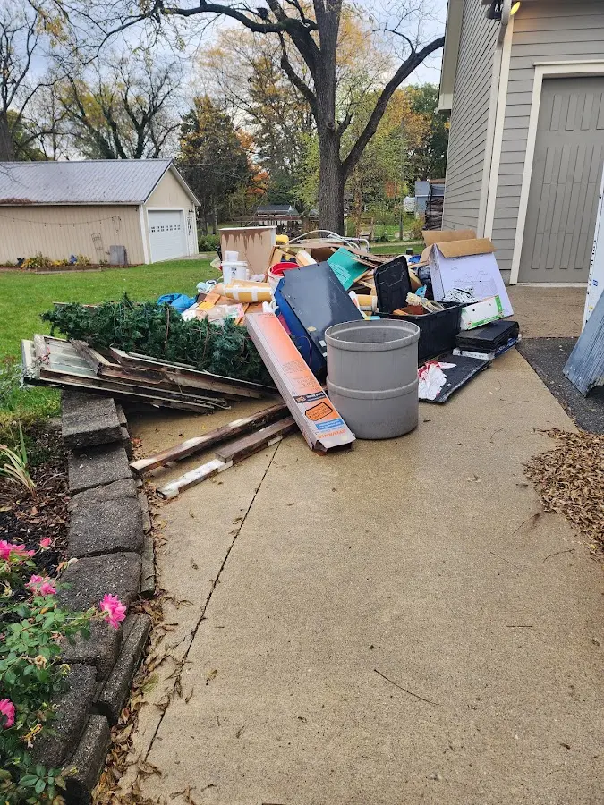 Dumpster being loaded with debris for Roofing Dumpster Rental in Lampasas